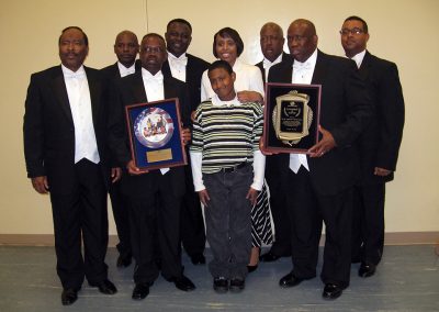 2013 photo of Big 7 with former Boys and Girls Club director Mrs. Dennis and child
